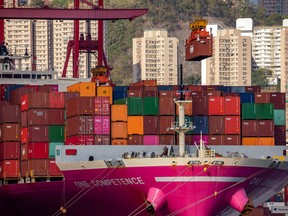 A gantry crane lifts a shipping container from the One Competence container ship at the Kwai Tsing Container Terminals in Hong Kong, China, on Wednesday, May 19, 2021. Hong Kong is scheduled to release trade figures on May 27. Photographer: