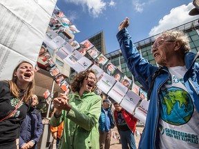 Members of the environmental group MilieuDefensie celebrate the verdict of the Dutch environmental organisation's case against Royal Dutch Shell Plc, outside the Palace of Justice courthouse in The Hague, Netherlands, on Wednesday, May 26, 2021.