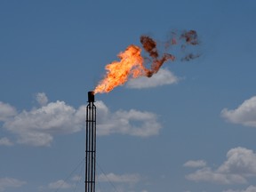 A flare burns off excess gas from a gas plant in the Permian Basin oil production area near Wink, Texas.
