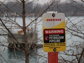 A sign marks the Enbridge Line 5 pipeline on the Canadian side of the St. Clair River. Central Canada and Michigan are in a standoff about this pipeline which carries 540,000 barrels of Western Canadian oil through a U.S. shortcut on the south side of the Great Lakes.