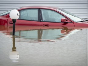 An automobile is submerged in flood waters in Sainte-Marthe-sur-le-Lac, a suburb of Montreal, Quebec, Canada,