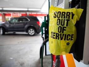 An "Out Of Service" bag covers a gas pump as cars continue line up for the chance to fill their gas tanks at a Circle K near uptown Charlotte, North Carolina following a ransomware attack that shut down the Colonial Pipeline.