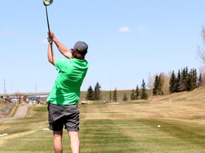 A golfer tees off at a Calgary course during the COVID-19 pandemic. William Watson argues that golf is one of the safer activities.