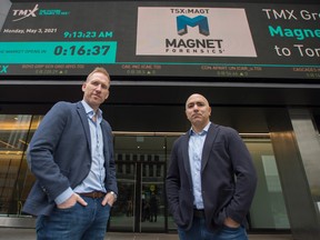 Magnet Forensics CEO Adam Belsher, left, and Jad Saliba, right, founder and chief technology officer, stand outside of the TSX building in Toronto where their company went public May 3, 2021.