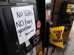 A sign reads in English and Spanish "No Gas" at a QuikTrip Corp. gas station in Chamblee, Georgia on Wednesday. U.S. national average retail gasoline prices have risen above $3 a gallon for the first time since 2014, after a cyberattack shut operations at Colonial Pipeline, the main supply link for the East Coast.