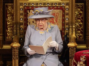 Britain's Queen Elizabeth II reads the Queen's Speech on the Sovereign's Throne in the House of Lords chamber during the State Opening of Parliament in London on May 11, 2021.