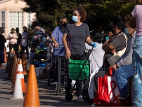 People wait in line as the Los Angeles Regional Food Bank distributes food outside a church in Los Angeles.