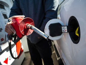 A man fills up his truck with gas in Toronto.