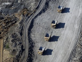 Dump trucks loaded with oilsands drive through the Suncor Energy Inc. mine near Fort McMurray.