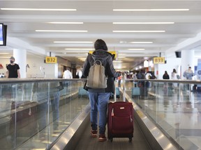 A traveller walks on a moving walkway in Terminal 4 at John F. Kennedy International Airport (JFK) in New York.