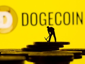 A small toy mining figure is seen on the cryptocurrency representation with Dogecoin logo in the background