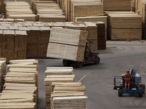Machines move lumber ready for shipping at the West Fraser Timber Co. sawmill in Quesnel, British Columbia.