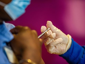 Nurse Valerie Massaro administers the second dose of the Pfizer/BioNTech vaccine to health care workers, twenty-one days after they received their first shot in Hartford, Connecticut.