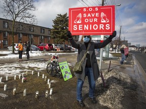 People demonstrate in support of the well-being of long-term care home residents outside a home in Scarborough, Ont., in February.