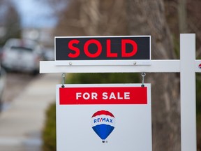 A sold sign in front of a home in Calgary