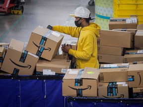 An employee scans packages at Amazon's JFK8 distribution centre in Staten Island, New York.