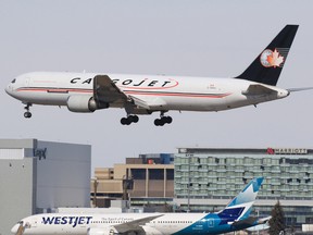 A Cargojet plane lands at the Calgary International Airport on Thursday, March 26, 2020.