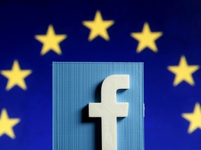 A 3D-printed Facebook logo is seen in front of the logo of the European Union