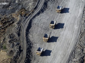 Dump trucks loaded with oilsands drive through the Suncor Energy Inc. mine in this aerial photograph taken near Fort McMurray.
