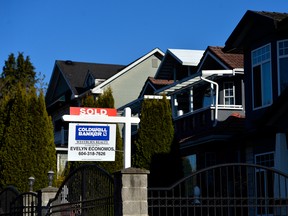 A sold sign in front of a house in British Columbia