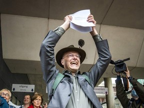 Director of Dutch environment organization 'Milieudefensie' Donald Pols reacts as he walks outside a court in The Hague on May 26, 2021, after the district court ruled that Anglo-Dutch multi-national Shell must reduce its emissions by 45 per cent by 2030.