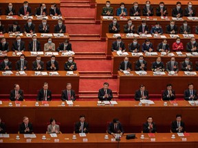 China's President Xi Jinping, center, and lawmakers in the Great Hall of the People in Beijing.