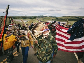 An Iraq War veteran, leads a protest march to a sacred burial ground at the Standing Rock Indian Reservation in North Dakota, Sept. 9, 2016.