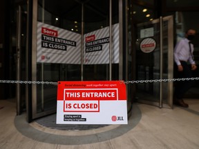An closed sign outside the entrance to an office building in the City of London, U.K.. Three lockdowns have left the U.K.’s financial center transformed.