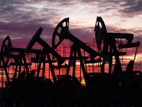 Oil pumping jacks, also known as "nodding donkeys", in an oilfield near Neftekamsk, in the Republic of Bashkortostan, Russia. The IEA made a direct plea to the OPEC+ alliance, which is led by those two countries, to continue restoring the output it cut when demand collapsed last year.