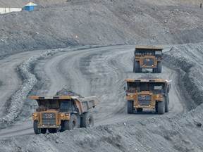 Dump trucks carrying the extracted gold ore from the mine site to the processing plant at the Kumtor gold mine.