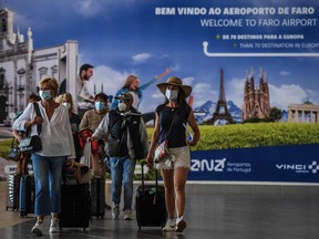 Passengers arrive at Faro airport in Algarve, south of Portugal, on May 17, 2021.