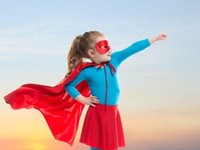 A little girl dressed as a superhero
