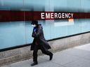 A woman walks past the emergency room entrance of Mount Sinai Hospital amid the coronavirus pandemic on March 31, 2020 in New York City. 