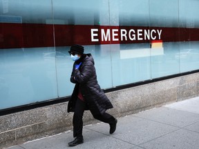 A woman walks by the emergency entrance to Mount Sinai Hospital amid the coronavirus pandemic on March 31, 2020 in New York City.