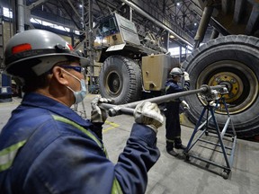 Kyrgyz workers repair machinery at the Kumtor gold mine on May 28, 2021.