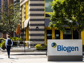 Pedestrians walk past Biogen Inc. headquarters in Cambridge, Massachusetts, U.S., on Monday, June 7, 2021. Biogen Inc. shares soared after its controversial Alzheimer's disease therapy was approved by U.S. regulators.