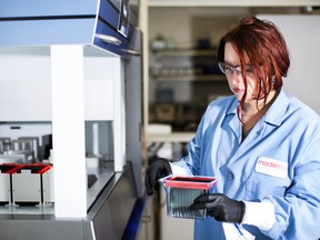 A research associate works at the Moderna lab in Cambridge, Massachusetts, in 2017.