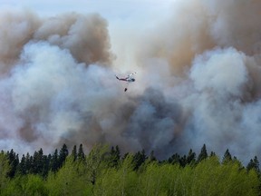 Water droppers battle an out-of-control forest fire in Prince Albert, Saskatchewan, May 18, 2021.