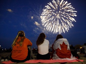 People watch fireworks fly over Ashbridges Bay during Canada Day festivities, on July 1, 2019 in Toronto.