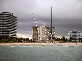 Search and Rescue teams look for possible survivors and to recover remains in the partially collapsed 12-story Champlain Towers South condo building on June 28, 2021 in Surfside, Florida.