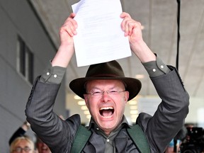 Donald Pols, Director of Milieudefensie (Friends of the Earth),  reacts holding a copy of a verdict in a case brought on against Shell by environmentalist and human rights groups, including Greenpeace and Friends of the Earth, who demand the energy firm to cut its reliance on fossil fuels, in The Hague, Netherlands, May 26, 2021.