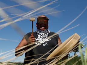 A man plays a drum during a prayer at the Mississippi headwaters on the third day of the Treaty People Gathering, an organized protest of the Line 3 pipeline, built by Enbridge Energy, in Solway, Minnesota, U.S., June 7, 2021.