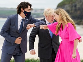 Awkward encounters abound: Prime Minister Justin Trudeau bumps elbows with Britain's Prime Minister Boris Johnson's spouse Carrie Johnson, next to Britain's Prime Minister Boris Johnson, during the G7 summit in Cornwall in June.