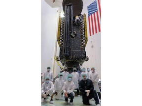 Maxar and SiriusXM employees pose for a photo with Maxar-built SXM-8 ahead of encapsulation in the fairing of SpaceX's Falcon 9 rocket in Cape Canaveral, Florida. Image credit: Maxar.