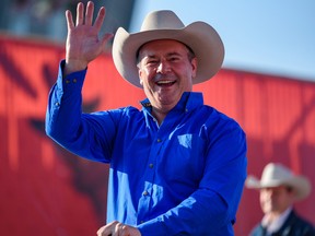 Premier Jason Kenney takes part in the Calgary Stampede parade on Friday, July 9. One of his government's biggest conundrums is how to coax the oil and gas industry to open up its collective pocketbook and create more jobs.