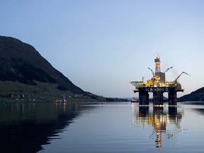 The Scarabeo 8 deepwater oil drilling rig, operated by ENI Norge AS, stands illuminated at night after being re-fitted at the Westcon AS yard in Olensvag, Norway.