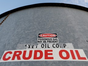 A sticker reads crude oil on the side of a storage tank in the Permian Basin in Mentone, Loving County, Texas.