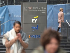 Pedestrians walk by the OMERS offices in Toronto.