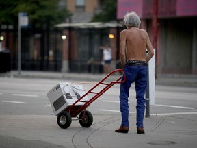 A resident transports an air conditioner during a heat wave in Vancouver.
