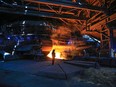 A steelworker watches as molten steel pours from one of the Blast Furnaces during 'tapping' at the British Steel - Scunthorpe plant in north Lincolnshire, north east England.